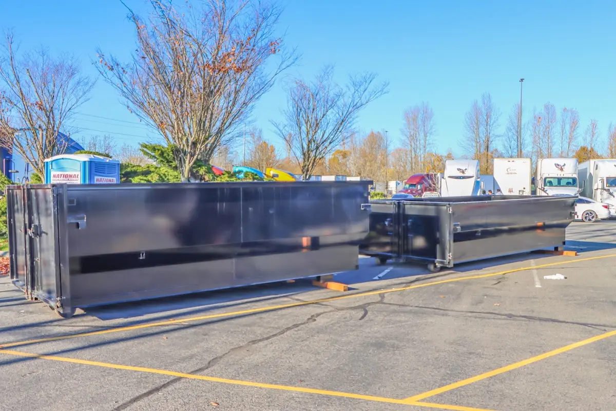 Professional dumpster rental service with roll-off container on residential driveway in Westerly